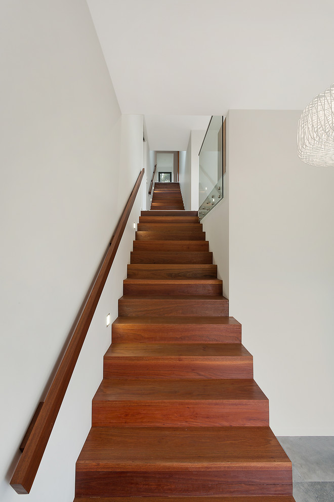Design ideas for a mid-sized modern wood straight staircase in Other with wood risers.
