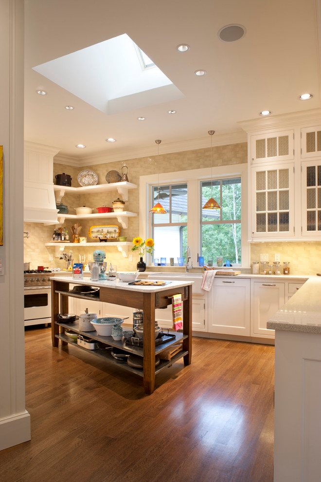 This is an example of a mid-sized traditional kitchen in Other with glass-front cabinets, terrazzo benchtops, a farmhouse sink, ceramic splashback, medium hardwood floors and white appliances.