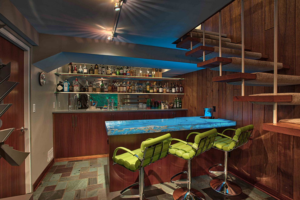 Inspiration for a small midcentury galley wet bar in Minneapolis with an undermount sink, flat-panel cabinets, medium wood cabinets, glass sheet splashback, ceramic floors and multi-coloured floor.