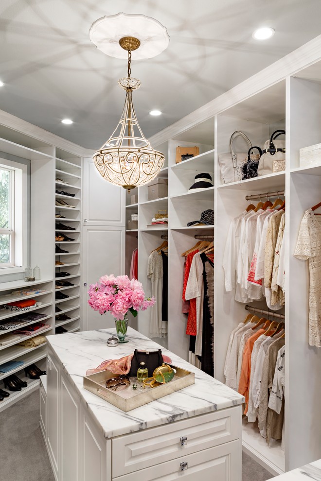 Design ideas for a large traditional women's walk-in wardrobe in Portland with raised-panel cabinets, white cabinets and carpet.