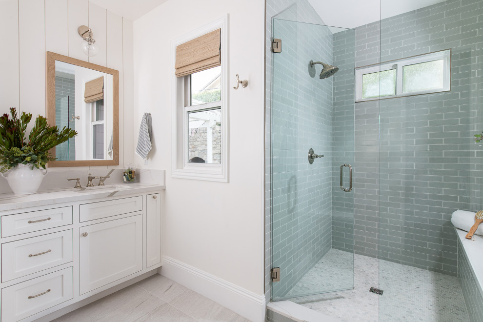 Design ideas for a nautical ensuite bathroom in Orange County with shaker cabinets, white cabinets, an alcove shower, white walls, porcelain flooring, a submerged sink, quartz worktops, white floors, a hinged door, white worktops, a shower bench, double sinks and a built in vanity unit.