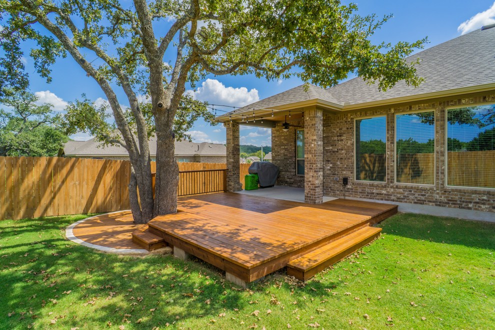 Inspiration for a mid-sized transitional backyard home design remodel in Austin with a roof extension
