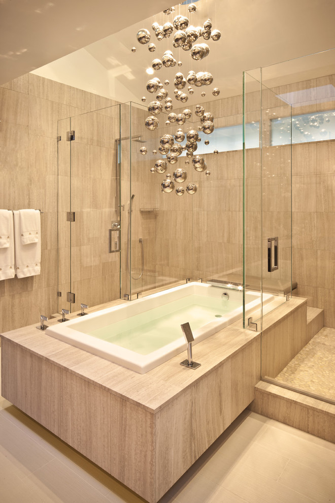 This is an example of a mid-sized contemporary master bathroom in Los Angeles with a drop-in tub, a corner shower, beige tile, porcelain tile, beige walls, beige floor and a hinged shower door.