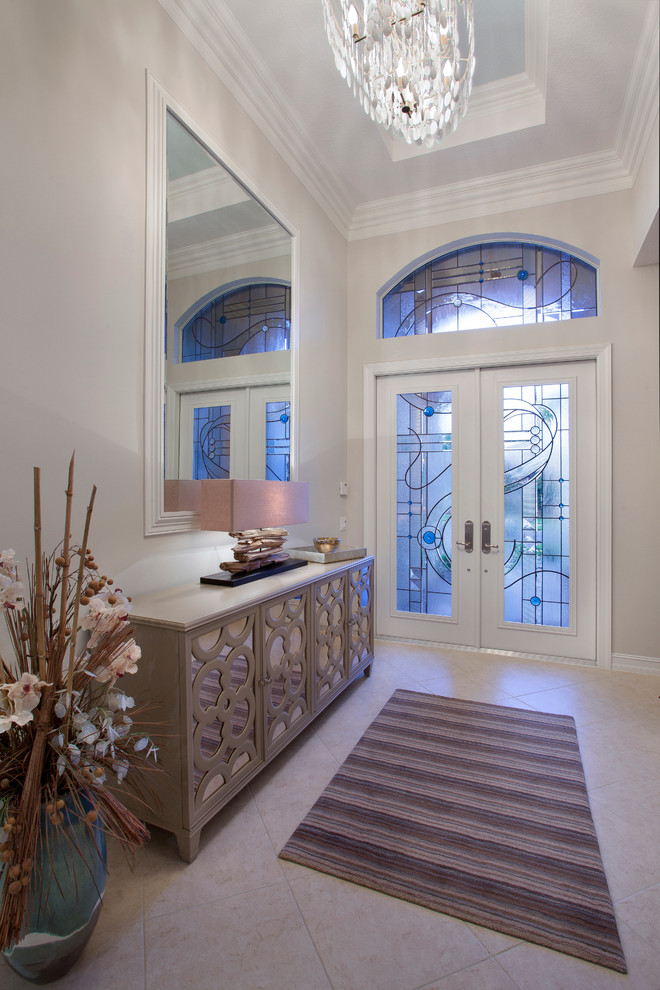Photo of a transitional foyer in Miami with beige walls, a double front door and a glass front door.