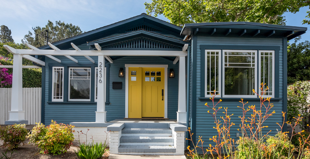 Design ideas for a mid-sized arts and crafts one-storey blue exterior in Los Angeles with wood siding and a gable roof.