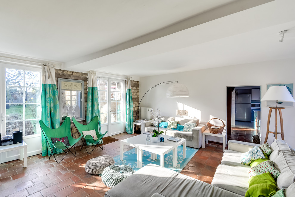 Large eclectic formal enclosed living room in Marseille with white walls, terra-cotta floors, no fireplace and no tv.