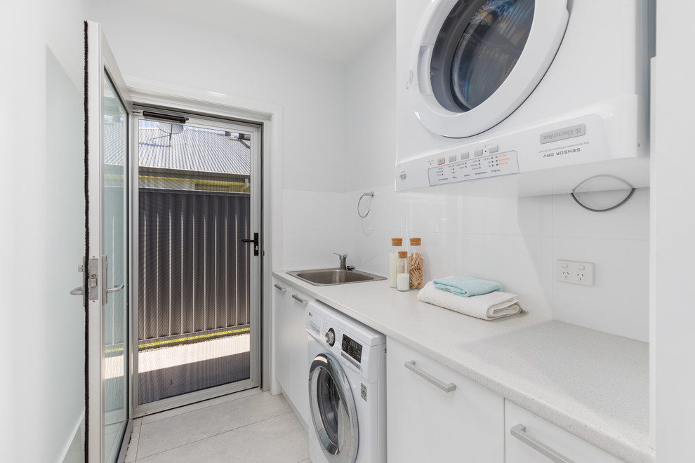This is an example of a beach style laundry room in Other.