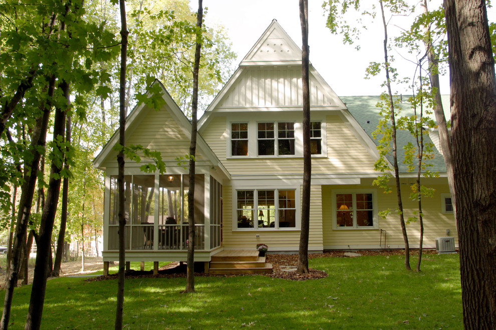This is an example of a mid-sized traditional two-storey exterior in Minneapolis with wood siding and a gable roof.