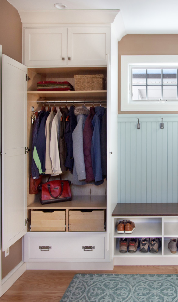Design ideas for a small transitional mudroom in New York with brown walls, medium hardwood floors and blue floor.