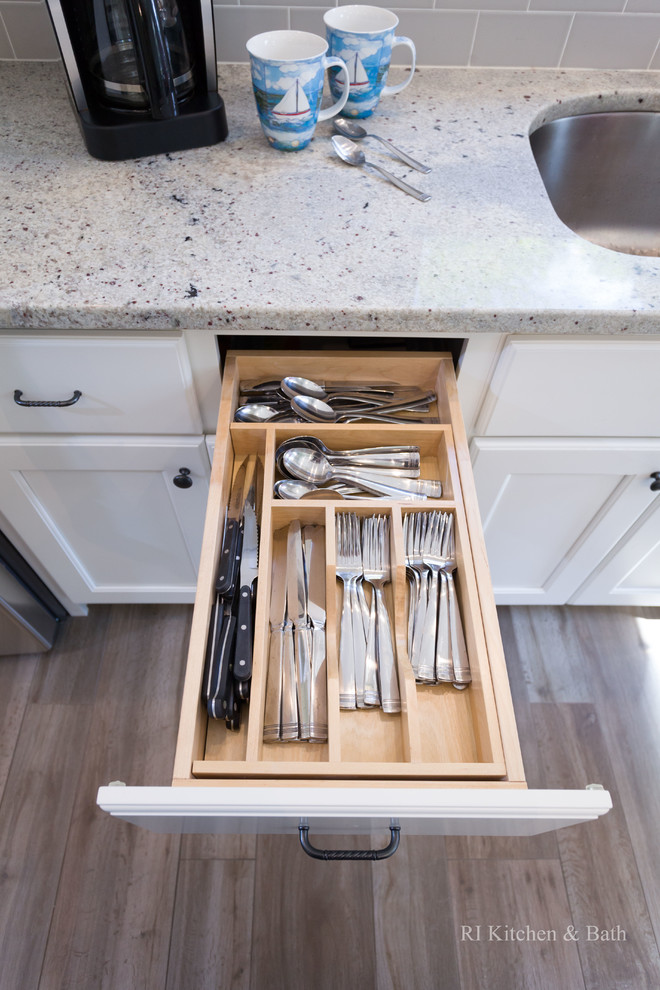 Example of a large transitional l-shaped porcelain tile eat-in kitchen design in Providence with an undermount sink, recessed-panel cabinets, white cabinets, granite countertops, gray backsplash, ceramic backsplash, stainless steel appliances, green walls and an island
