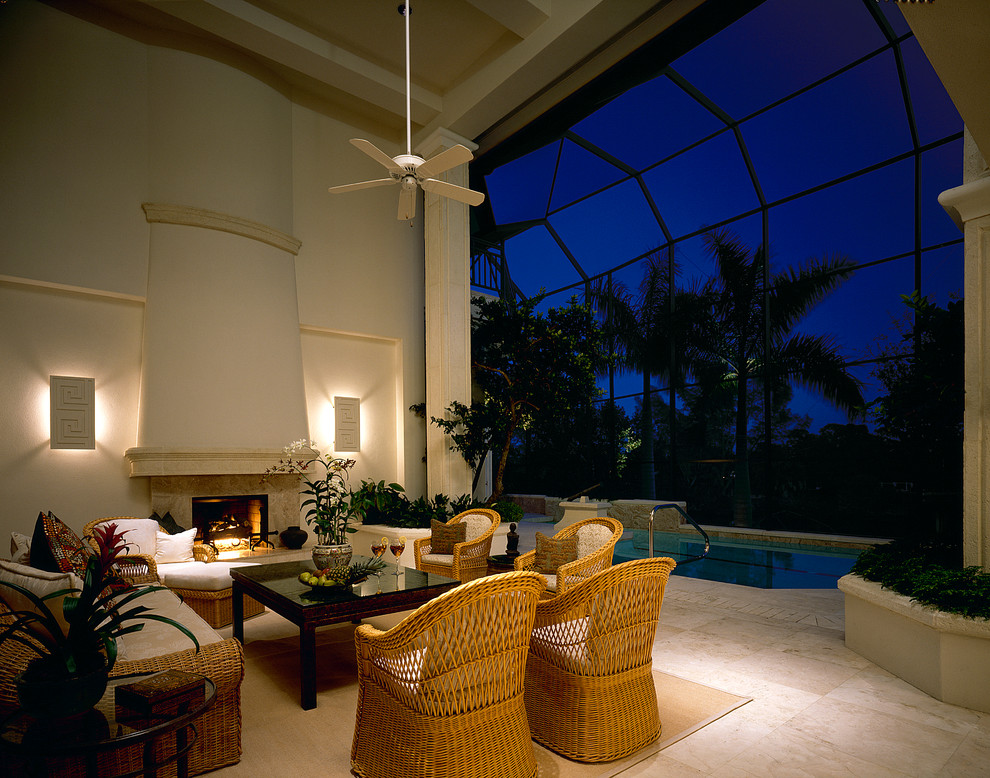 Design ideas for a traditional patio in Miami with a fire feature and a roof extension.