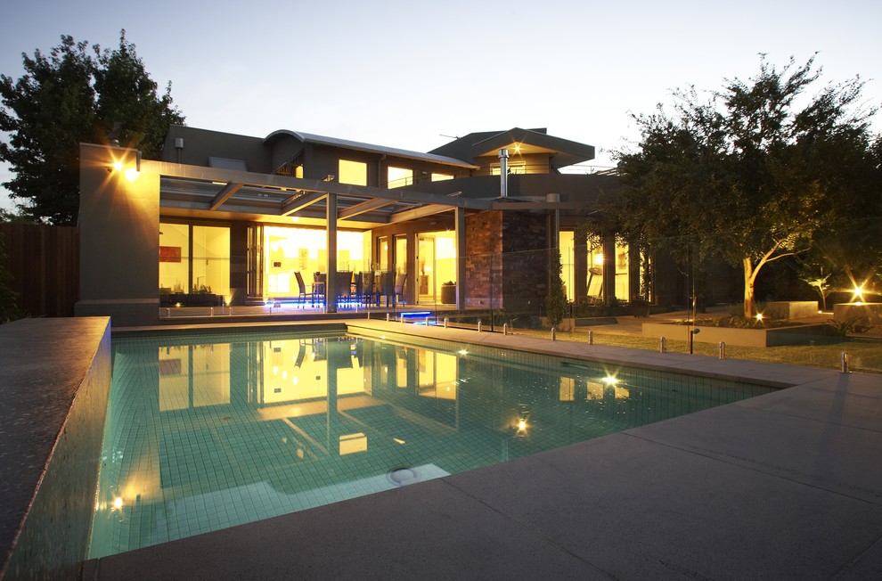 Photo of a mid-sized contemporary backyard rectangular pool in Melbourne with concrete pavers.