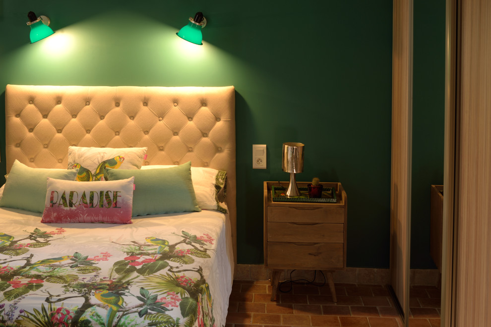Design ideas for a mid-sized midcentury master bedroom in Marseille with green walls and terra-cotta floors.