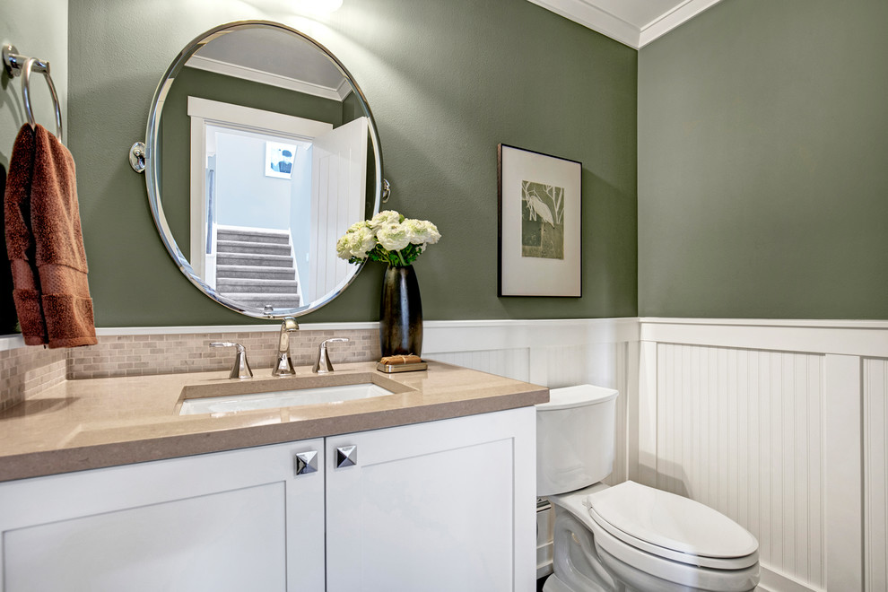 Traditional bathroom in Seattle with recessed-panel cabinets, white cabinets, a two-piece toilet, beige tile, green walls, porcelain floors, an undermount sink and engineered quartz benchtops.