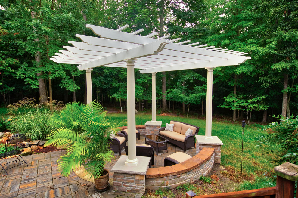 This is an example of a mid-sized transitional backyard patio in Richmond with tile and a pergola.