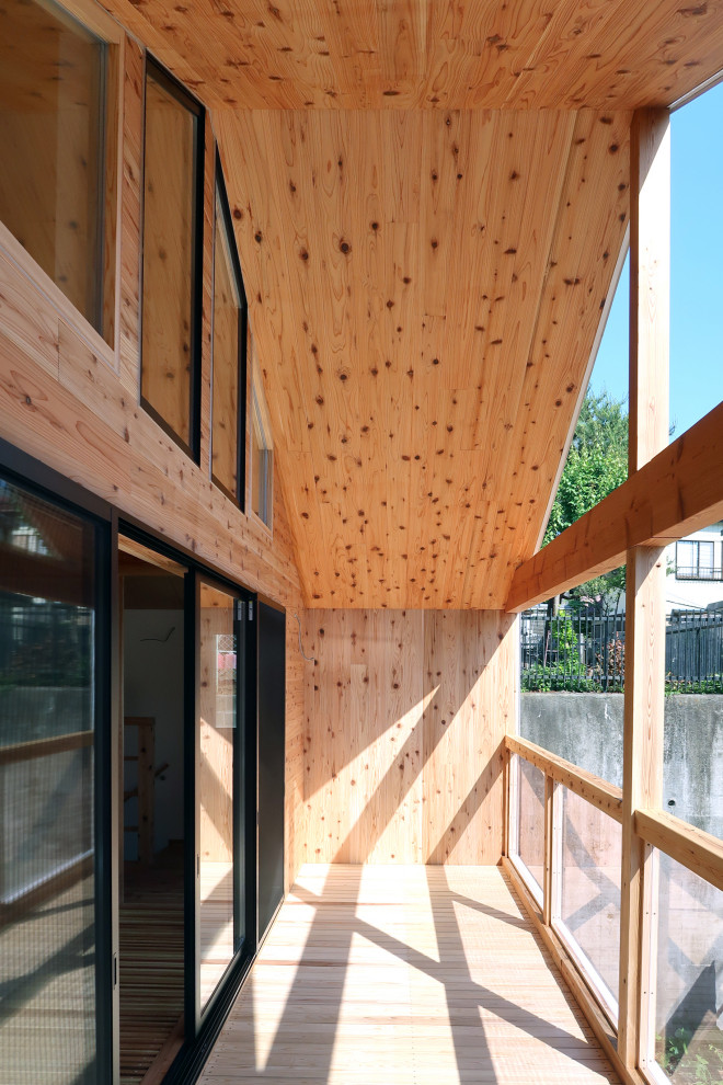 Inspiration för moderna balkonger, med takförlängning och räcke i trä