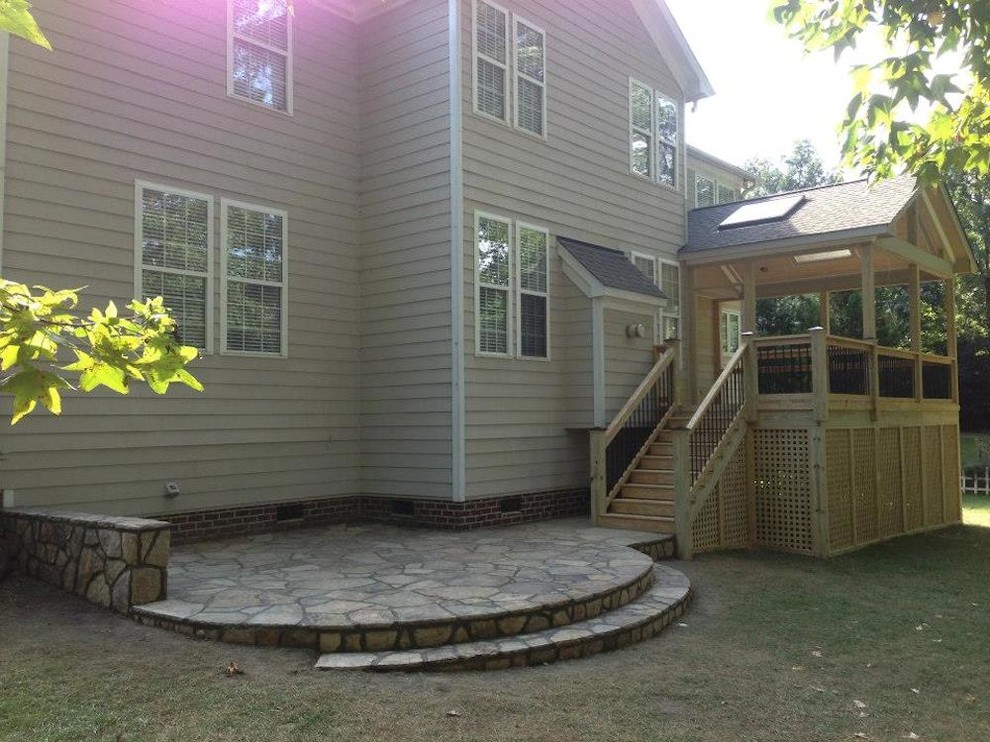 Photo of a mid-sized transitional side yard deck in Raleigh with a roof extension.