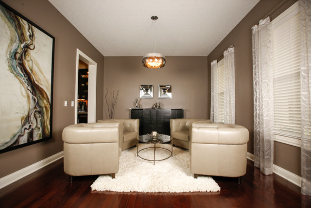 This is an example of a contemporary dining room in Columbus with grey walls and medium hardwood floors.