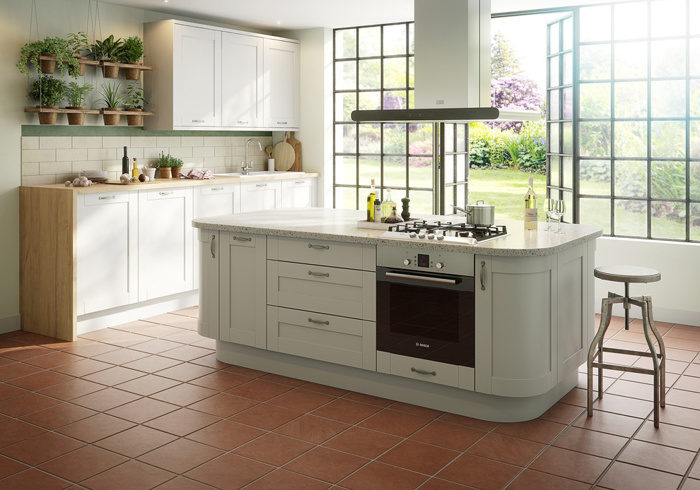 Design ideas for a large traditional single-wall eat-in kitchen in Hampshire with white splashback, subway tile splashback, stainless steel appliances, terra-cotta floors and with island.