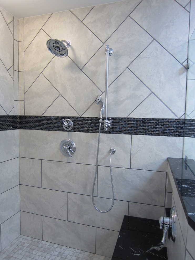 This is an example of a large modern master bathroom in Other with an undermount sink, raised-panel cabinets, white cabinets, marble benchtops, a drop-in tub, an alcove shower, gray tile, ceramic tile, grey walls and ceramic floors.