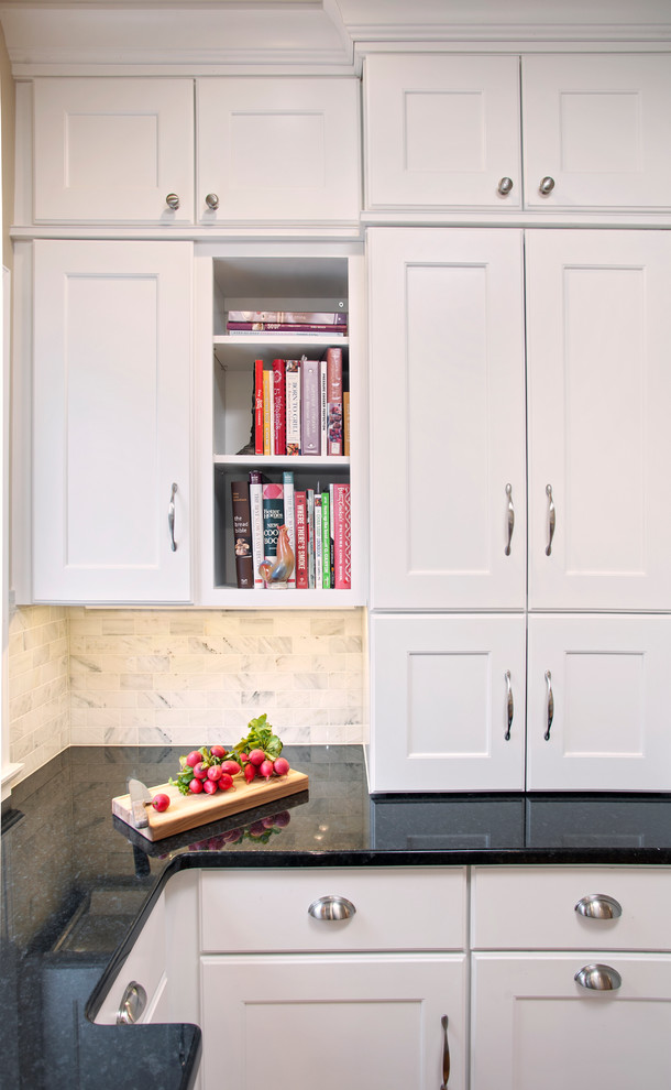 Kitchen - transitional kitchen idea with recessed-panel cabinets, white cabinets, granite countertops, gray backsplash, stone tile backsplash and a peninsula