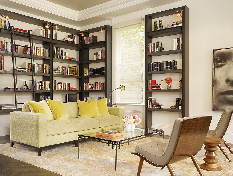 This is an example of a transitional living room in San Francisco with a library, white walls and dark hardwood floors.