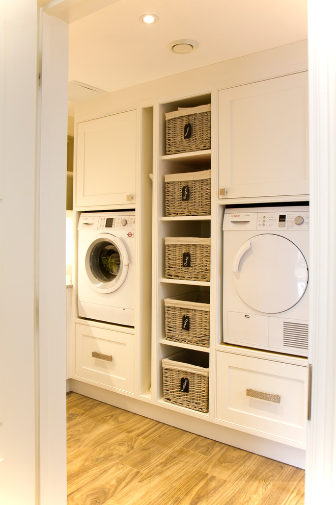 Inspiration for a mid-sized traditional l-shaped utility room in Dorset with shaker cabinets, white cabinets, quartzite benchtops and a side-by-side washer and dryer.