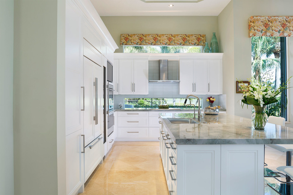 Mid-sized transitional l-shaped porcelain tile and beige floor eat-in kitchen photo in Miami with an undermount sink, recessed-panel cabinets, white cabinets, marble countertops, stainless steel appliances, an island, gray countertops, gray backsplash and ceramic backsplash