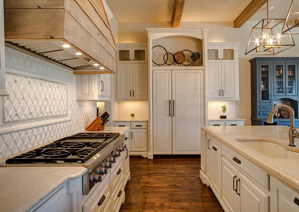 Inspiration for a large transitional eat-in kitchen in Dallas with an undermount sink, raised-panel cabinets, beige cabinets, marble benchtops, beige splashback, ceramic splashback, stainless steel appliances, dark hardwood floors, with island, brown floor and beige benchtop.