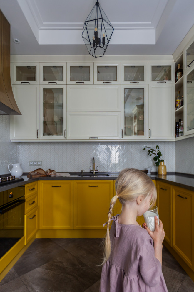 Photo of a small traditional u-shaped separate kitchen in Moscow with an undermount sink, raised-panel cabinets, yellow cabinets, quartz benchtops, white splashback, mosaic tile splashback, coloured appliances, porcelain floors, brown floor, brown benchtop and coffered.