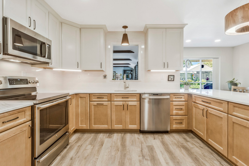 Huge transitional u-shaped kitchen pantry photo in DC Metro with an undermount sink, recessed-panel cabinets, quartz countertops, white backsplash, subway tile backsplash, stainless steel appliances, a peninsula and white countertops