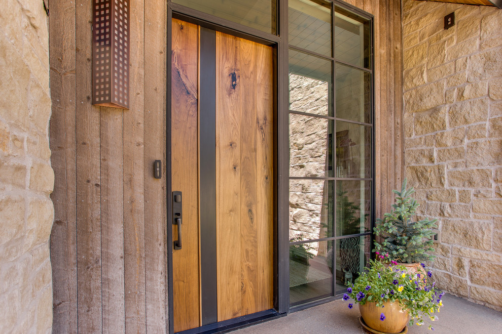 This is an example of a mid-sized contemporary front door in Denver with concrete floors, a single front door and a medium wood front door.