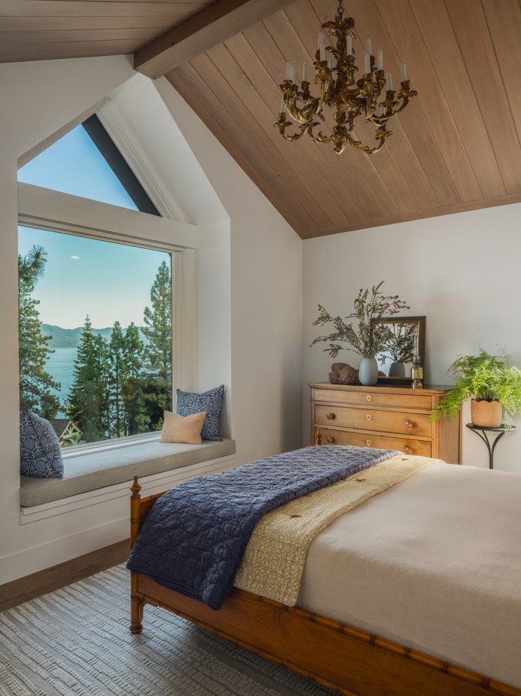 Mid-sized mountain style guest medium tone wood floor, brown floor and vaulted ceiling bedroom photo in Other with white walls