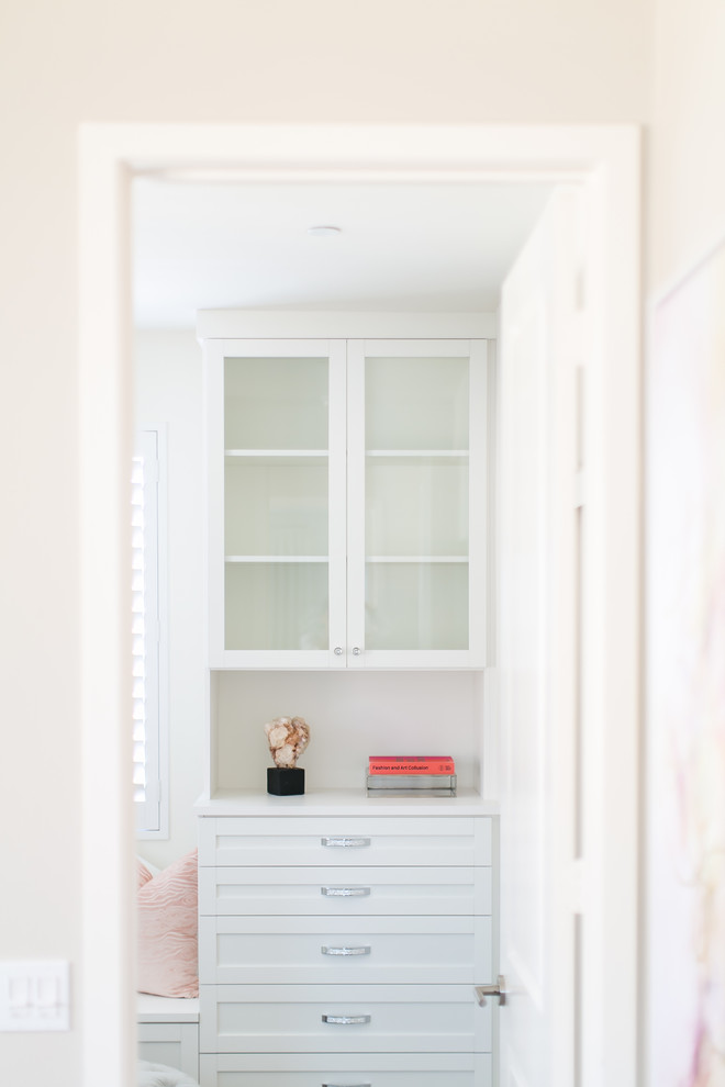 Large transitional walk-in closet photo in Orange County