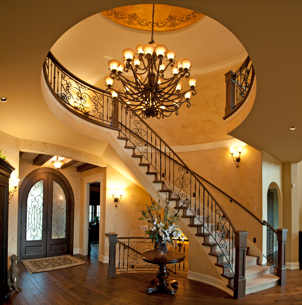 Photo of a mediterranean wood curved staircase in Vancouver.
