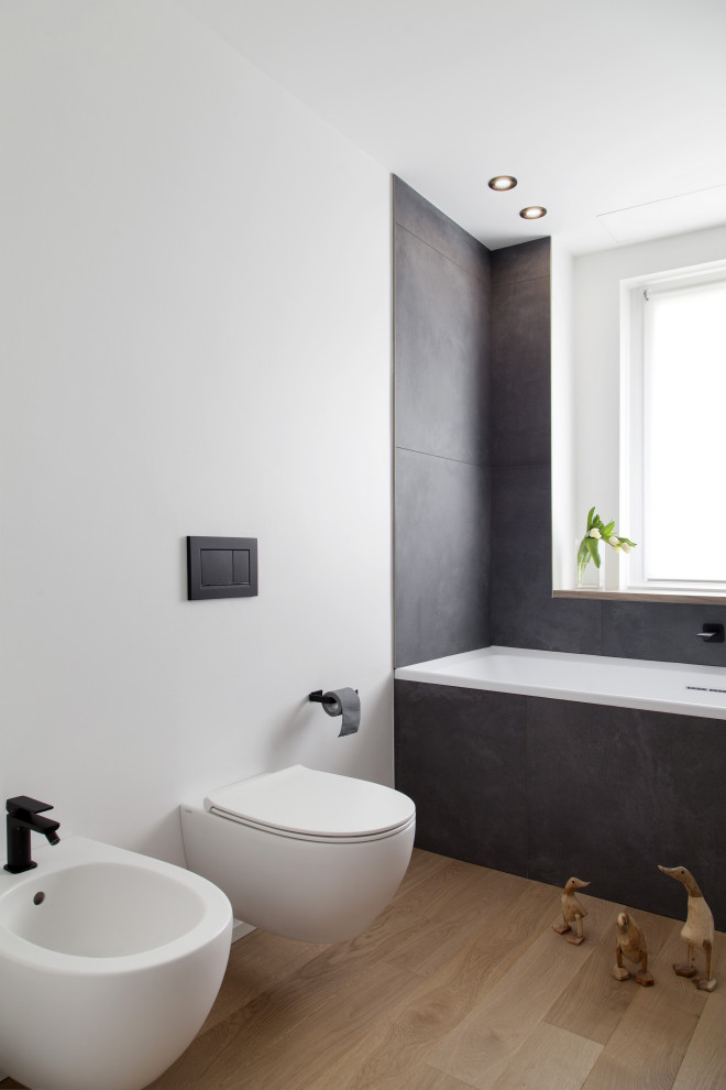 Photo of a contemporary powder room in Milan with pebble tile floors and a vessel sink.
