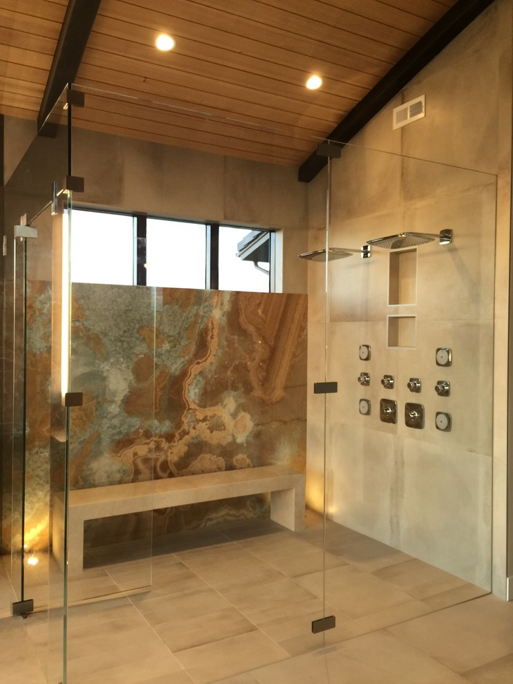This is an example of an expansive modern master bathroom in San Francisco with flat-panel cabinets, medium wood cabinets, a freestanding tub, a curbless shower, a one-piece toilet, brown tile, marble, brown walls, porcelain floors, a vessel sink, marble benchtops, beige floor and a hinged shower door.