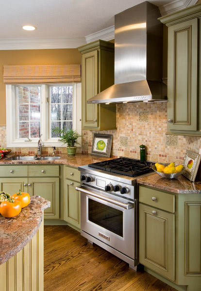 Eat-in kitchen - transitional medium tone wood floor eat-in kitchen idea in Indianapolis with green cabinets, granite countertops, multicolored backsplash, stainless steel appliances and an island