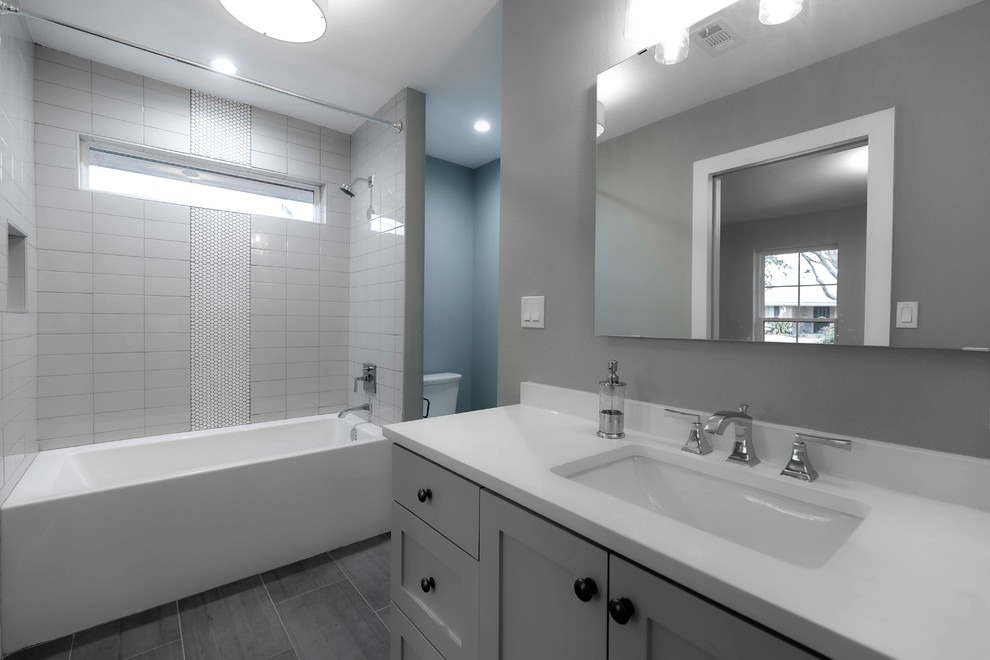 This is an example of a small transitional kids bathroom in Dallas with shaker cabinets, white cabinets, an alcove shower and porcelain floors.