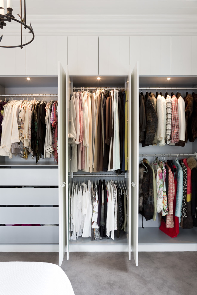 Design ideas for a large traditional gender-neutral walk-in wardrobe in Sydney with white cabinets, carpet and flat-panel cabinets.