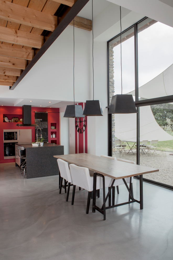 Example of a huge country open concept exposed beam family room design in Rennes with white walls, no fireplace and no tv
