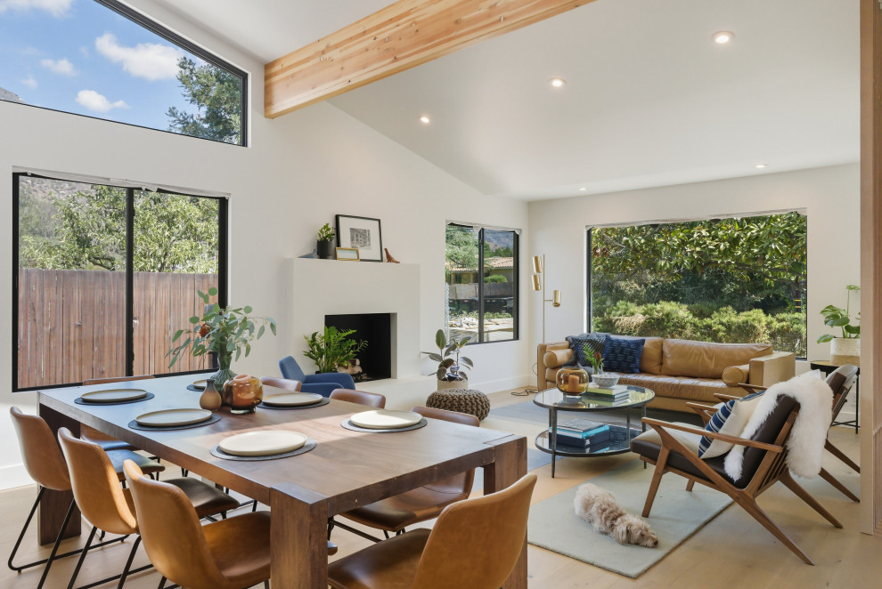 1960s light wood floor, beige floor, exposed beam and vaulted ceiling great room photo in Portland with white walls