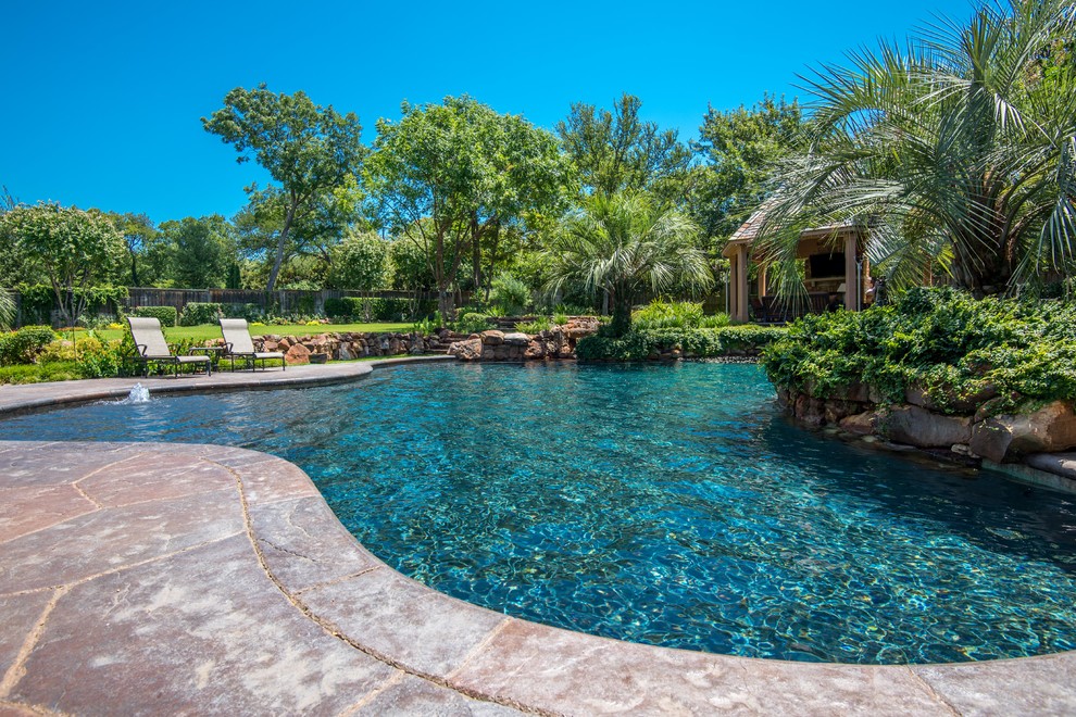 Inspiration for a traditional backyard pool in Dallas with a pool house.