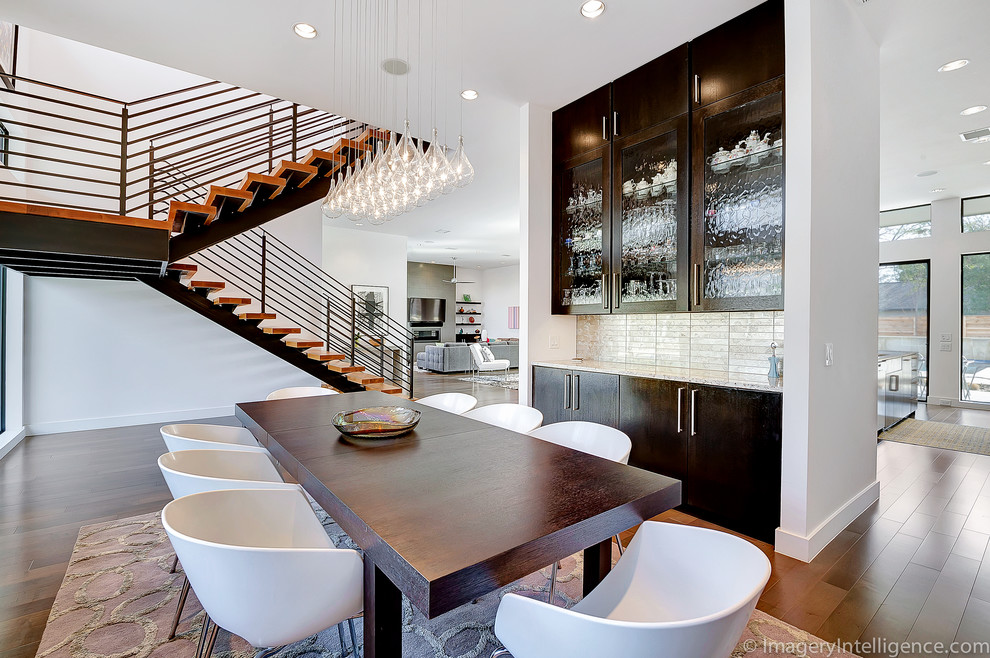 Photo of a contemporary dining room in Dallas with white walls and dark hardwood floors.