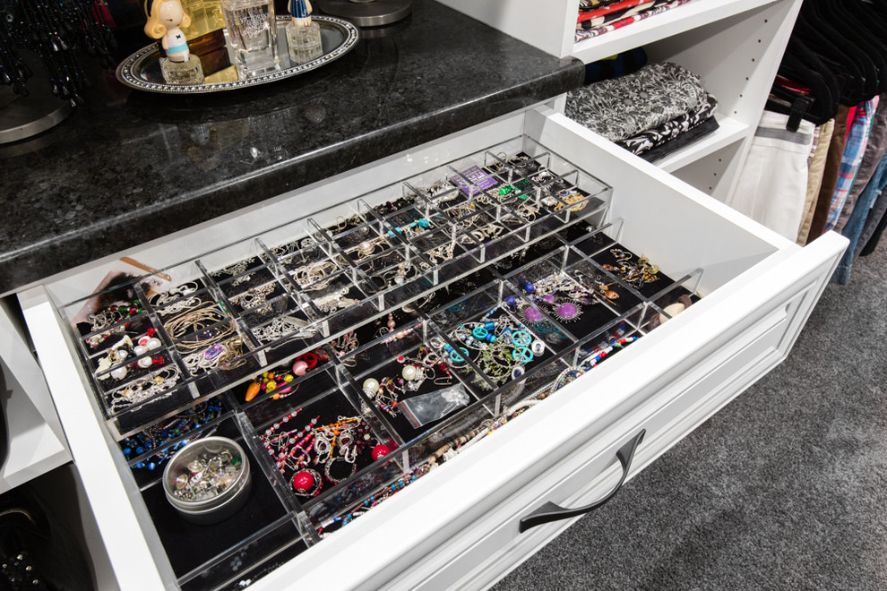 Example of a large classic carpeted walk-in closet design in Chicago with raised-panel cabinets and white cabinets