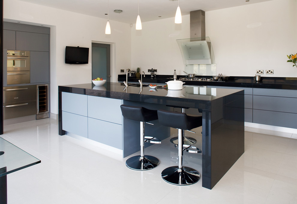 Design ideas for a contemporary kitchen in Other with stainless steel appliances, flat-panel cabinets, grey cabinets and glass sheet splashback.