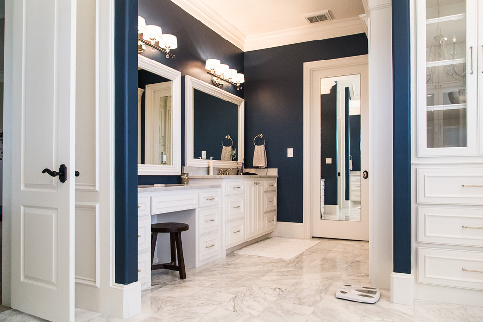 Expansive traditional master wet room bathroom in Austin with beaded inset cabinets, white cabinets, a freestanding tub, a two-piece toilet, blue walls, marble floors, an undermount sink, granite benchtops, grey floor and a hinged shower door.