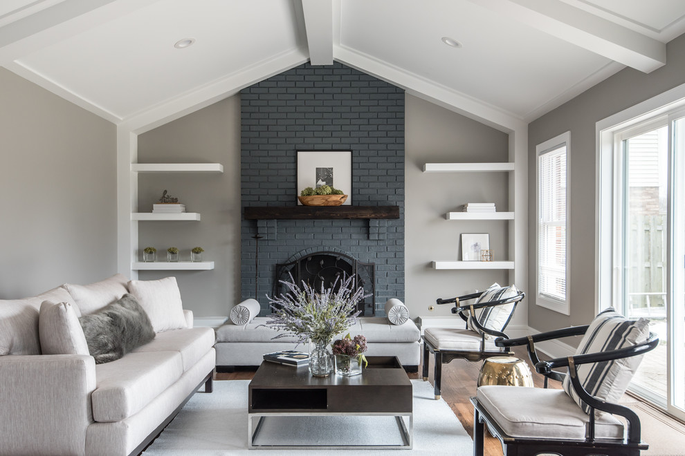 Inspiration for a mid-sized transitional formal open concept living room in Chicago with grey walls, dark hardwood floors, a standard fireplace, a brick fireplace surround, no tv and brown floor.