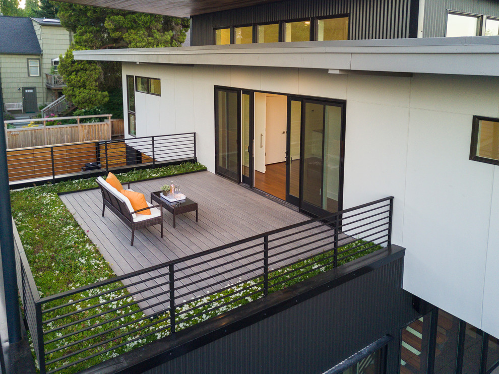 Photo of a mid-sized modern rooftop deck in Seattle with a roof extension.