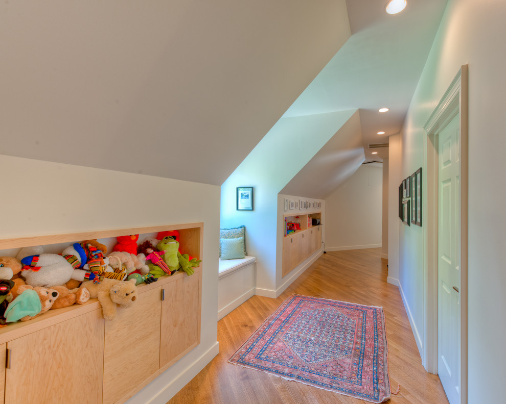 This is an example of a transitional kids' room in Charlotte with white walls.